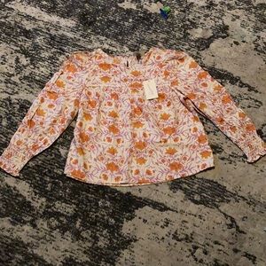 New! Women’s long sleeve blouse with peak a boo back.